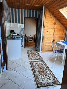 a kitchen with a white refrigerator and a table at Horváth apartaman in Hévíz