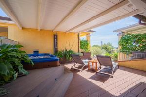 a patio with two chairs and a hot tub at Hotel Lu Pitrali in San Teodoro