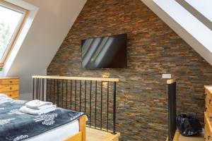 Televízia a/alebo spoločenská miestnosť v ubytovaní Biathlon Park - Apartament VIP