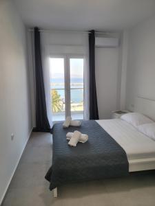 a bedroom with a bed with two towels on it at Iraklitsa Port View in Iraklitsa