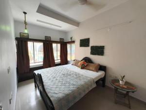 sypialnia z dużym łóżkiem i stołem w obiekcie Calcutta Backpackers w mieście Kolkata