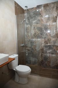 een badkamer met een douche, een toilet en een wastafel bij KOKINO Winery & Hotel in Kumanovo