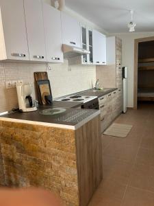 a kitchen with white cabinets and a counter top at Kaliopi HAUS in Nea Moudania +10 photos