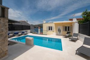a swimming pool on the roof of a house at Lavanda Residence with Heated Pool Trogir Split in Okrug Donji