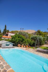 a swimming pool in a yard next to a house at dreamcatcher in Anavissos