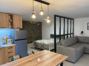 a kitchen and living room with a couch and a table at Apartman Vesna in Divčibare