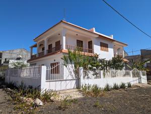 a white house with a fence in front of it at Apartment Funana Tarrafal in Tarrafal