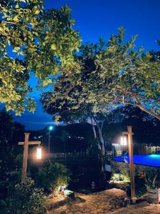 a pair of crosses and a tree at night at 6Senses Garden Homestay in Hòa Bình