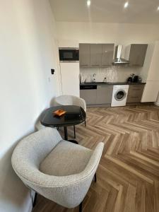 een woonkamer met een tafel en stoelen en een keuken bij PALAIS DES FESTIVALS à 3 min - Croisette - Plage in Cannes