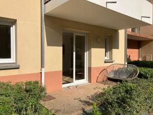 a building with a bench in front of it at appartementT2 à 2 pas du circuit in Le Mans