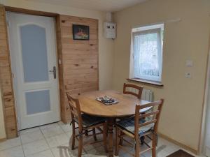 a dining room with a wooden table and chairs at PETIT MAS COSY DU BORD DE LOIRE a 15 MM DU PARC LE PAL in Diou +33 photos