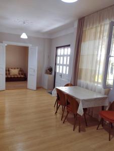 a room with a table and chairs and a bedroom at Guest House Arsha in Kazbegi