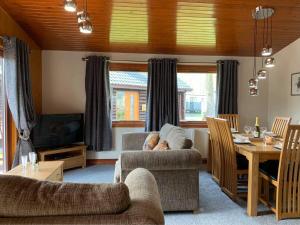 a living room with a couch and a table at Heron lodge in Tattershall