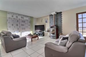 a living room with two couches and a fireplace at Grande maison avec jardin in Sarrancolin