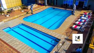 an overhead view of a large blue swimming pool at Armaflex Hotel Lira in Lira