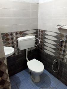 a bathroom with a toilet and a sink at Kalina Asian Dormitory in Mumbai