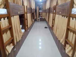 a hallway of rows of bunk beds in a room at Kalina Asian Dormitory in Mumbai