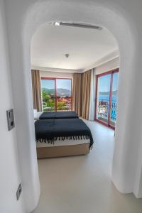 a bedroom with a bed with a view of the ocean at Hotel Begonvil in Kas