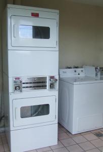 two white appliances sitting next to each other in a kitchen at Americas Best Value Inn Beaumont in Beaumont