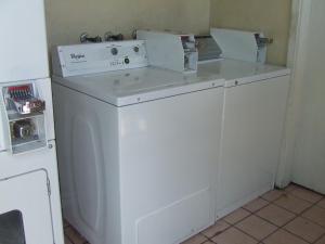 Una lavadora y secadora con dos cajas encima. en Americas Best Value Inn Beaumont, en Beaumont
