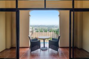 a view from the balcony of a house with a table and chairs at Mövenpick Hotel Jeddah in Jeddah