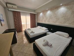 Postel nebo postele na pokoji v ubytování Hotel Pini