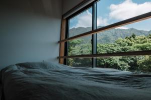 Postel nebo postele na pokoji v ubytování Årc yakushima