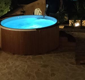 a hot tub in a backyard at night at Villa Sasà in Fiskardo