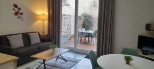 a living room with a couch and a table at L'ETOILE DE MER in Sète