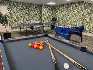 a pool table with cue sticks and balls on it at Hotel Collingwood BW Signature Collection in Bournemouth
