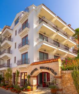 a large white building with balconies on it at Hotel Begonvil in Kas