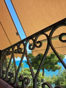 a close up of a metal fence with a window at La Casa sulla Scogliera Acciaroli in Acciaroli