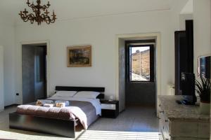 a bedroom with a bed and a window and a chandelier at Il Castello di Atessa in Atessa