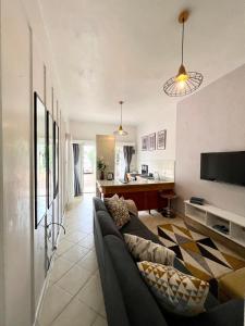a living room with a couch and a kitchen at 1 bedroom cottage Westlands central location -by Zuri homes in Nairobi
