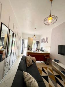 a living room with a couch and a kitchen at 1 bedroom cottage Westlands central location -by Zuri homes in Nairobi