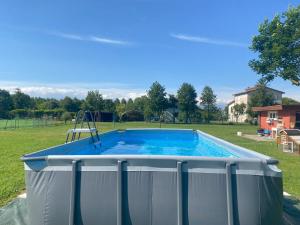 a large swimming pool in a yard at Cygnus Bed & Breakfast in Lido di Jesolo