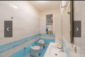 a bathroom with a white toilet and a sink at La Casa sulla Scogliera Acciaroli in Acciaroli