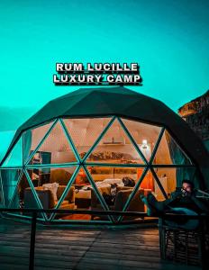 a man sitting in a glass iguanauana camp at Rum Lucille Luxury camp in Wadi Rum