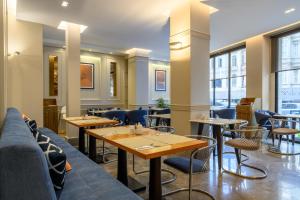 a restaurant with tables and chairs and windows at Four Points Express by Sheraton Istanbul Taksim Square in Istanbul