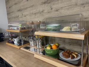 a kitchen counter with a plate of food on a shelf at Logis Hôtel Le Bocage in Montmarault