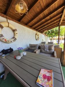 a wooden table in a living room with a couch at Акра-Ф in Chernomorets