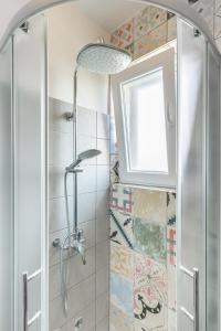 a bathroom with a shower with a glass door at Hostel Casa La Cha in Novalja +129 photos