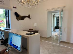 a person taking a picture of a desk with a computer at Relais Corte Degli Aragonesi in Ischia