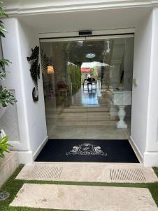 a glass door leading to aoyer with a table at Relais Corte Degli Aragonesi in Ischia