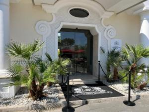 a building with palm trees in front of a door at Relais Corte Degli Aragonesi in Ischia