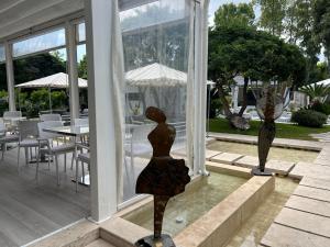 a statue of a woman sitting on the front of a house at Relais Corte Degli Aragonesi in Ischia