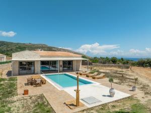 a villa with a swimming pool and a house at Pantheon Luxury Villas in Skala Kefalonias