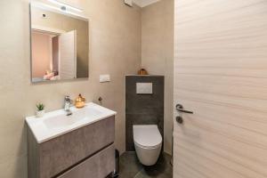 a bathroom with a sink and a toilet and a mirror at Apartmani Krtica 1 in Vrbnik +31 photos