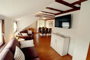 ein Wohnzimmer mit einem Sofa und einem TV in der Unterkunft Haus Sonnentau in Monschau
