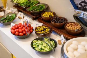 a display of fruits and vegetables in bowls on a counter at Four Points Flex by Sheraton Istanbul Taksim Square in Istanbul +59 photos